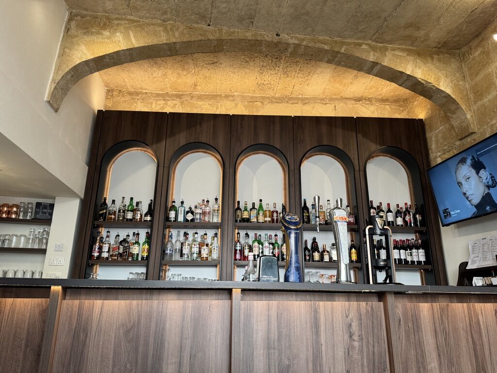 The bar with draught beer taps and a full back bar of spirits